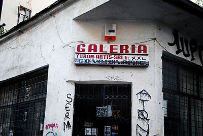 A mix of official writing and street lettering on a sign made for a some kind of turism agency.